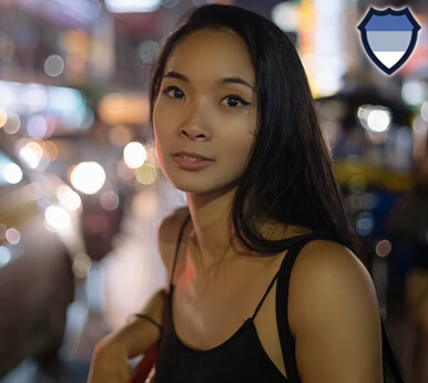 Asian lady beside a busy street