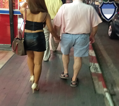 Bar girl walking with a customer in Pattaya