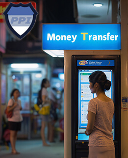 Thai lady outside a money transfer booth