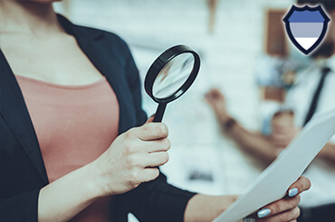 Investigator checking documents with a magnifying glass